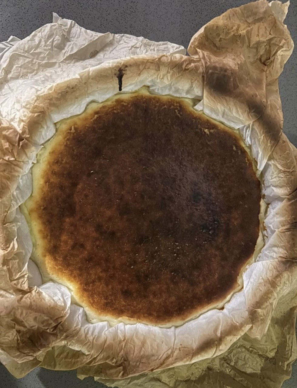 A whole Basque burnt cheesecake fresh from the oven in parchment
