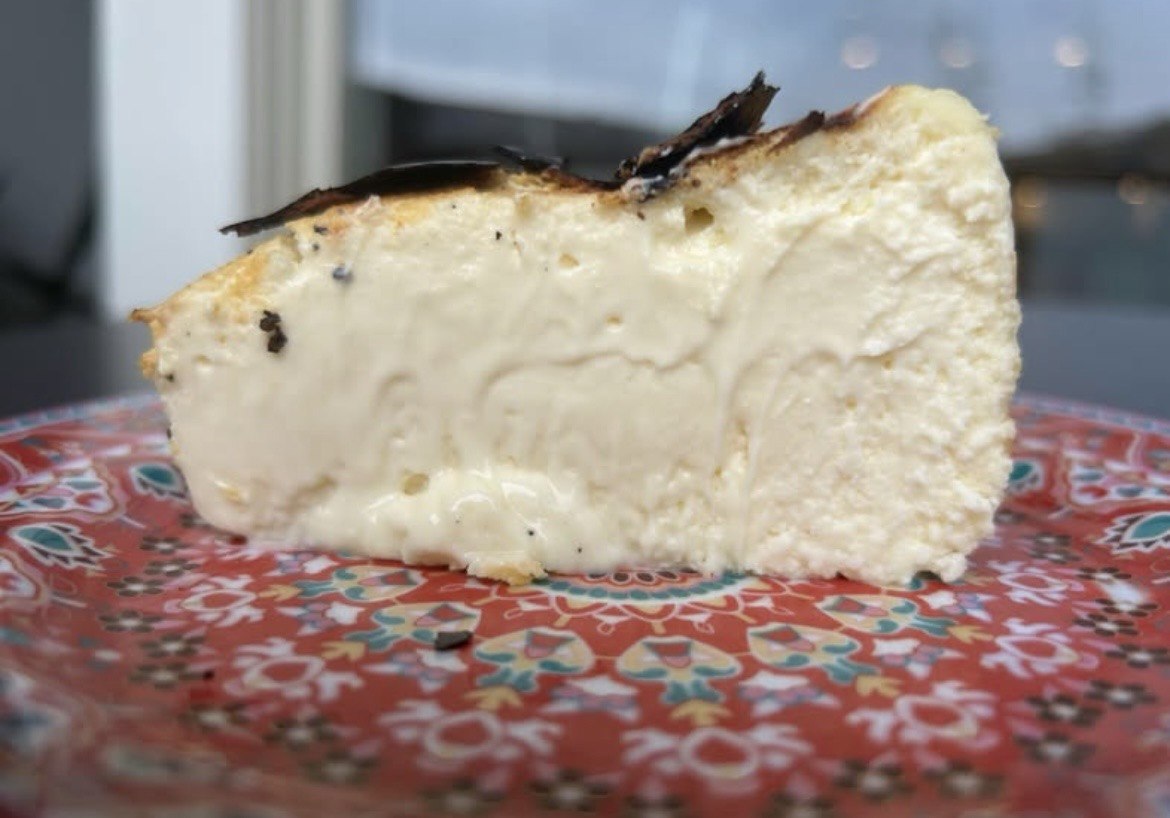 A creamy slice of Basque burnt cheesecake on a patterned plate