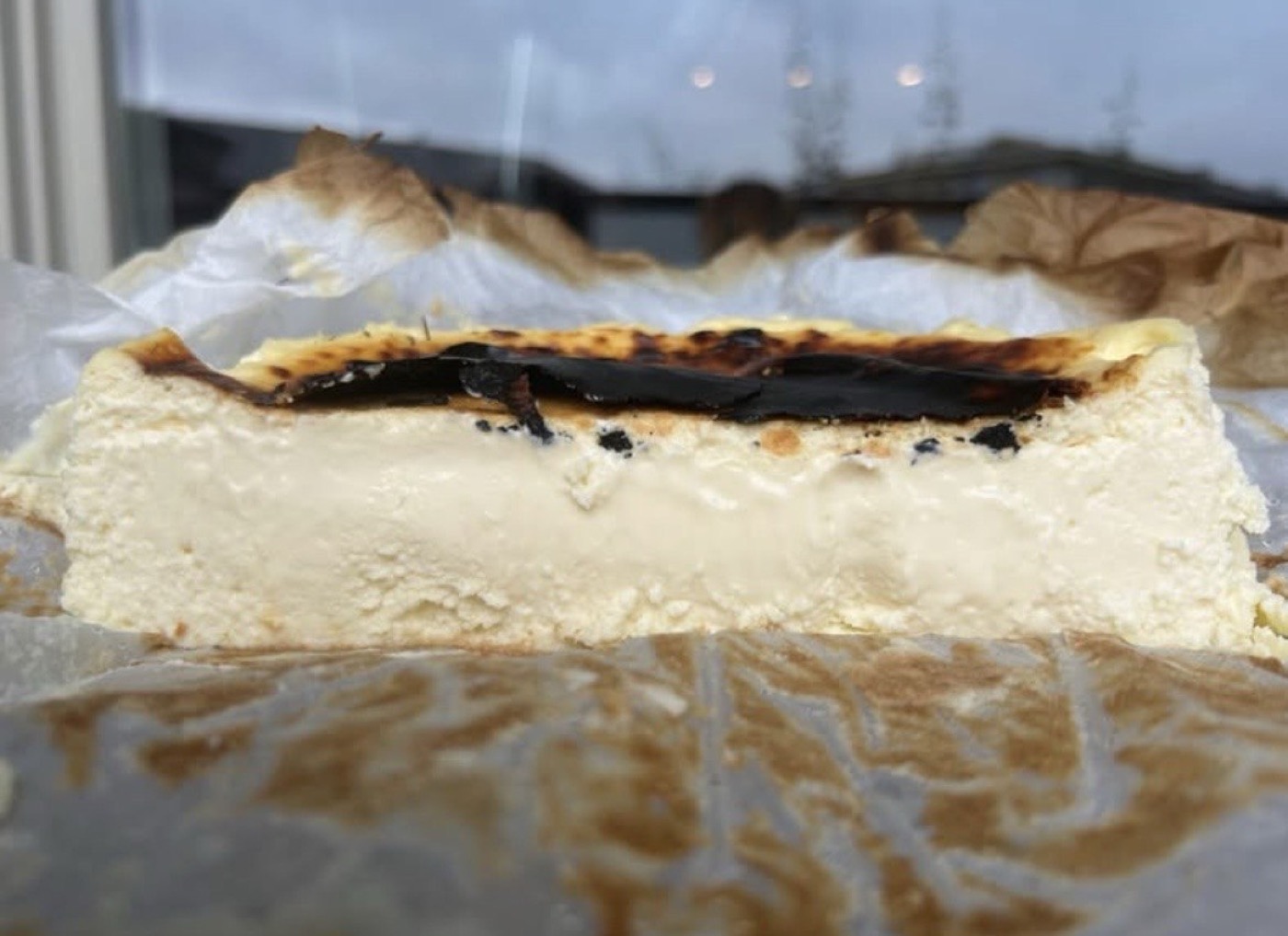 A freshly baked Basque burnt cheesecake resting on parchment